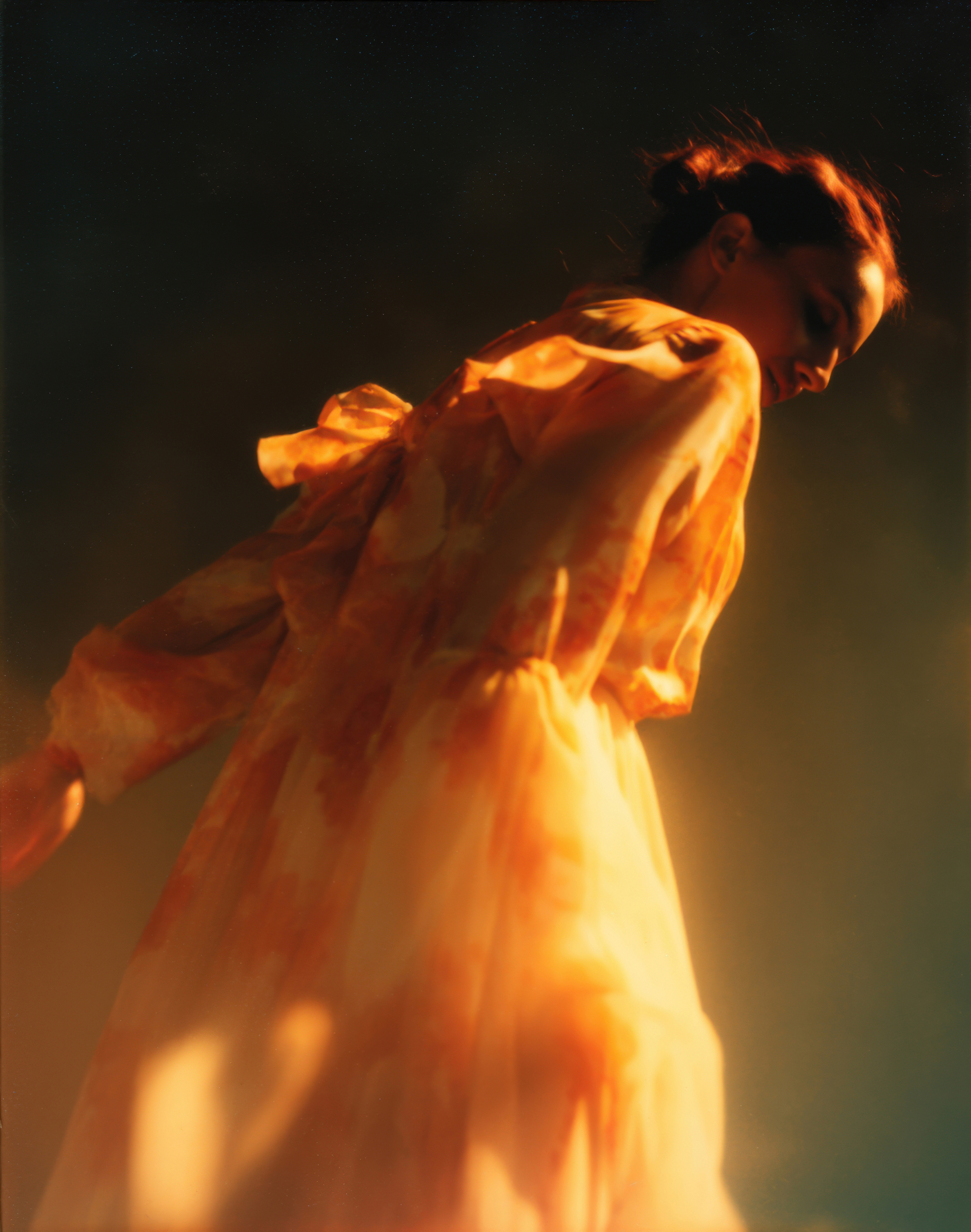 A person moving through warm light